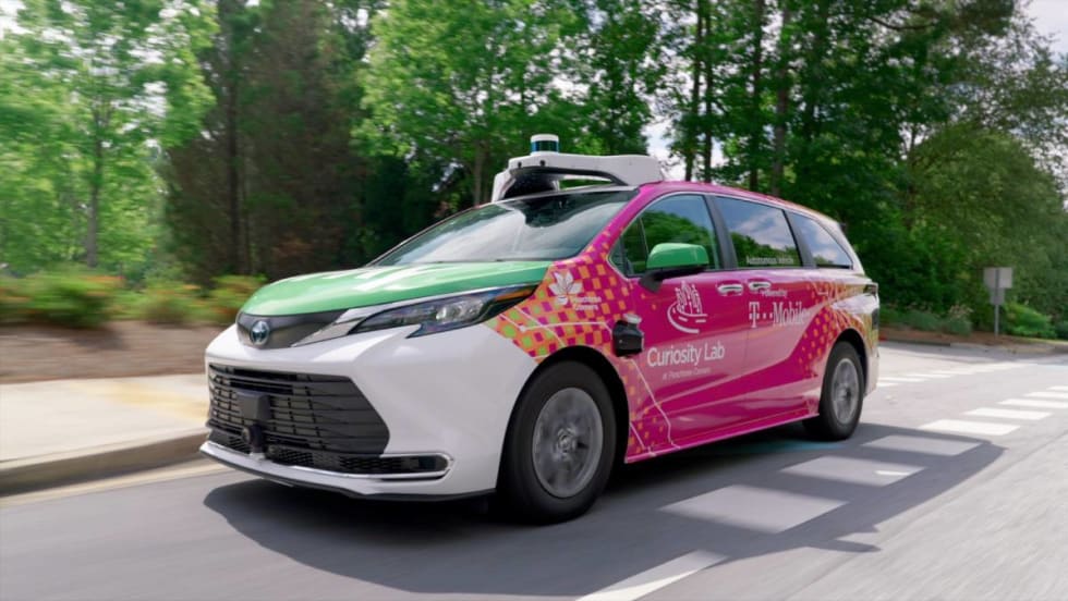 A fully automated May Mobility vehicle driving on the road.