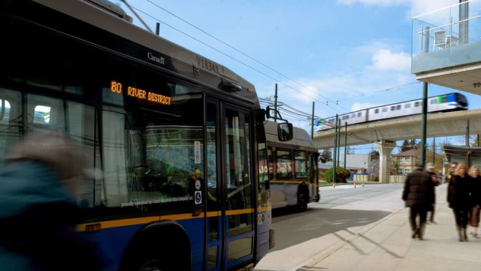 Pedestrians approaching a parked bus.