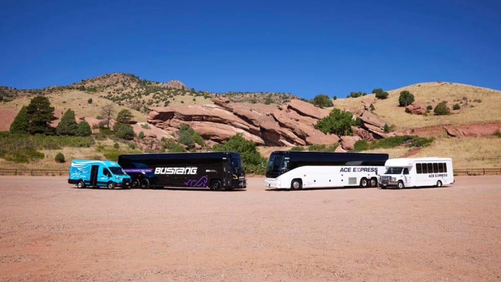 A Bustang and ACE Express motorcoach in front of a mountain