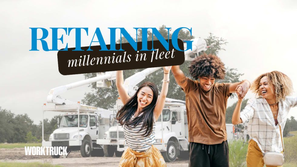 Happy millennials in front of work trucks