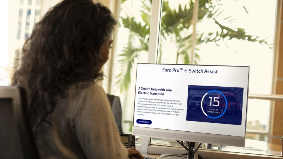 Women on computer looking at Ford Pro's E-Switch Assist