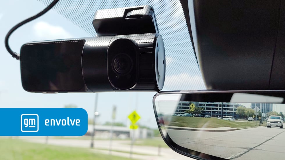 photo of a dashcam mounted adjacent to mirror inside a pickup truck
