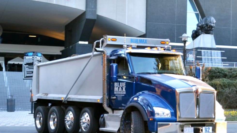 Photo of blue dump truck.