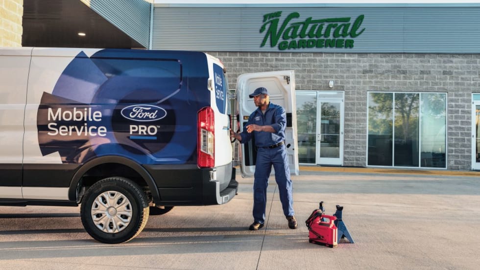 A Ford Pro Mobile Service technician working on-site at a customer’s location.