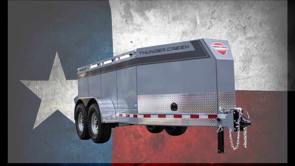 Fuel tank trailer against background of a Texas flag.