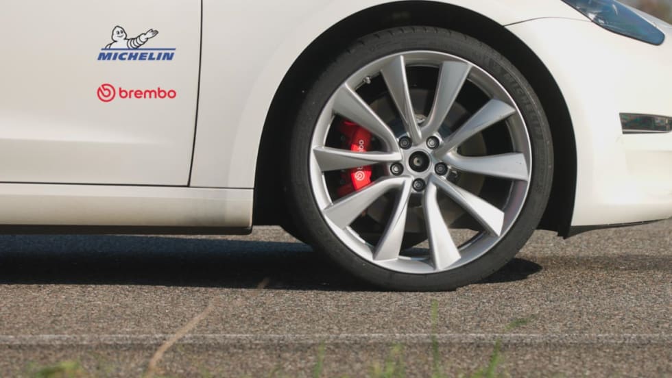 Photo of wheel of car and brakes with logos on car for Michelin and Brembo.