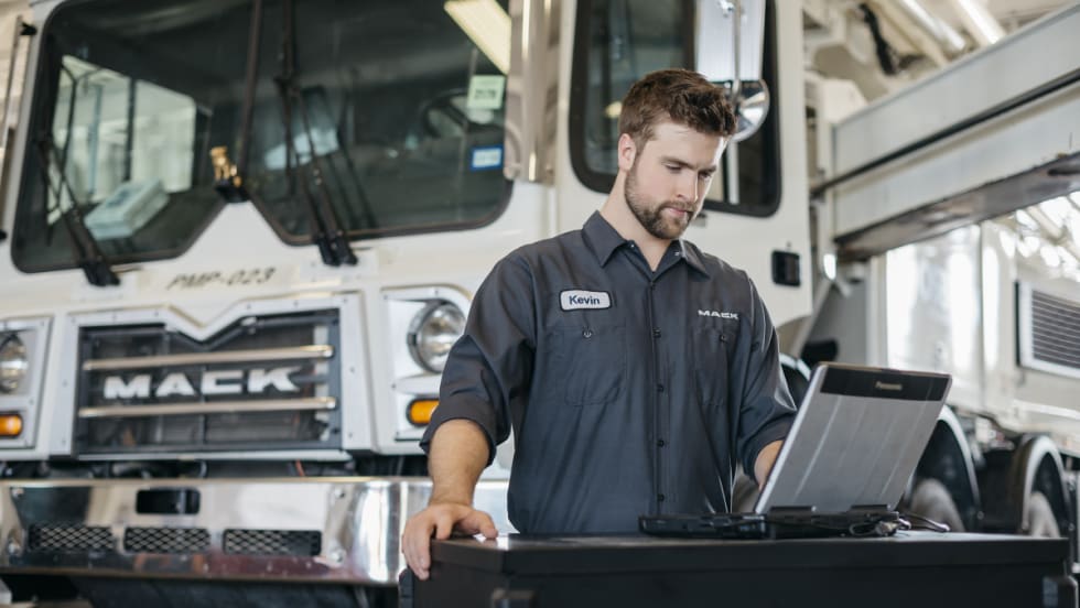 Mack Truck with technician on laptop