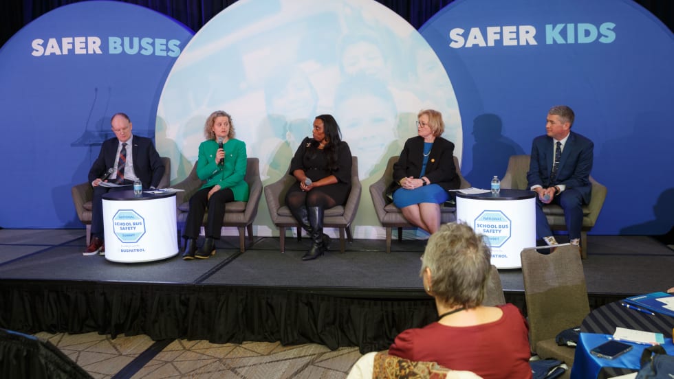 A panel of people on a stage.