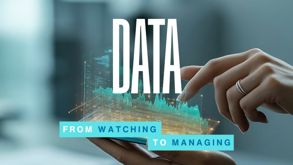 A hand interacts with a digital data display above a smartphone, symbolizing how fleets use real-time insights to manage trucks, drivers, and daily operations.