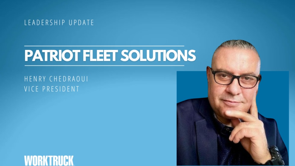 Man in business attire in front of a blue background with company name, Patriot Fleet Solutions.