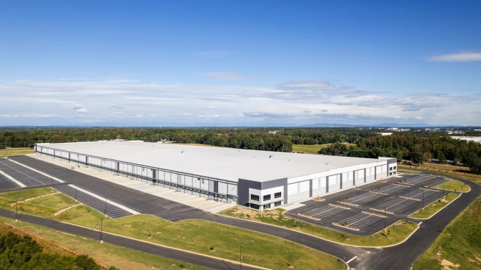 Aerial view of a large white manufacturing building.