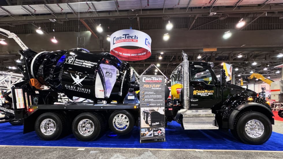 side photo of a black concrete truck