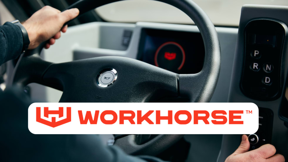 Interior photo of a truck and steering wheel with logo for Workhorse in a white box.