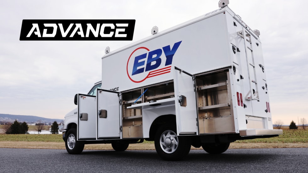 quarter-side rear view of a white service truck with cabinet doors open.