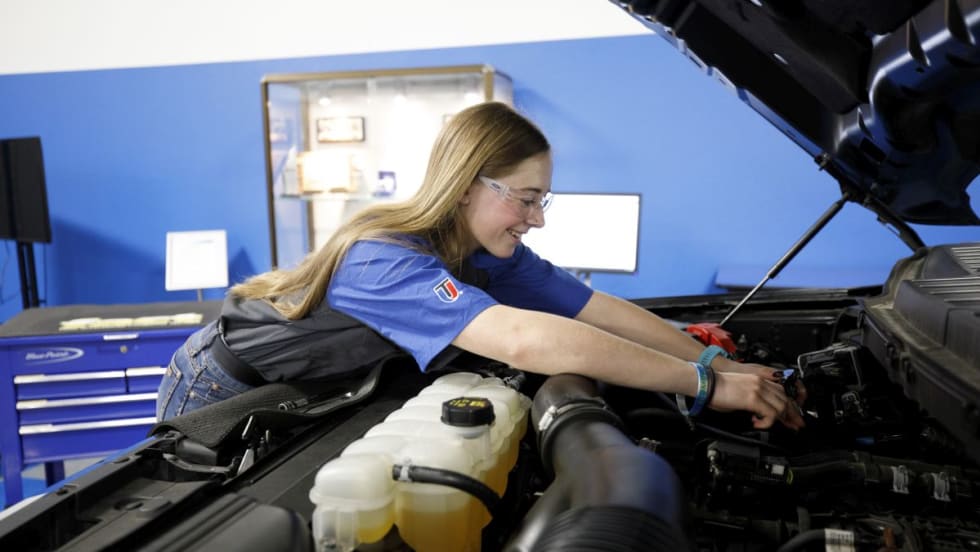 Makenna Enga working on a vehicle