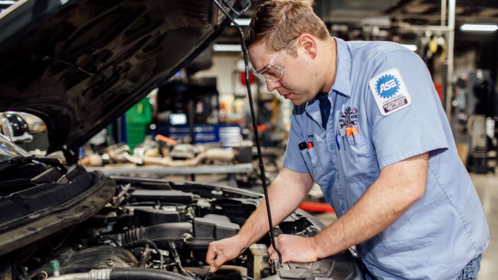 ASE technician working on a vehicle