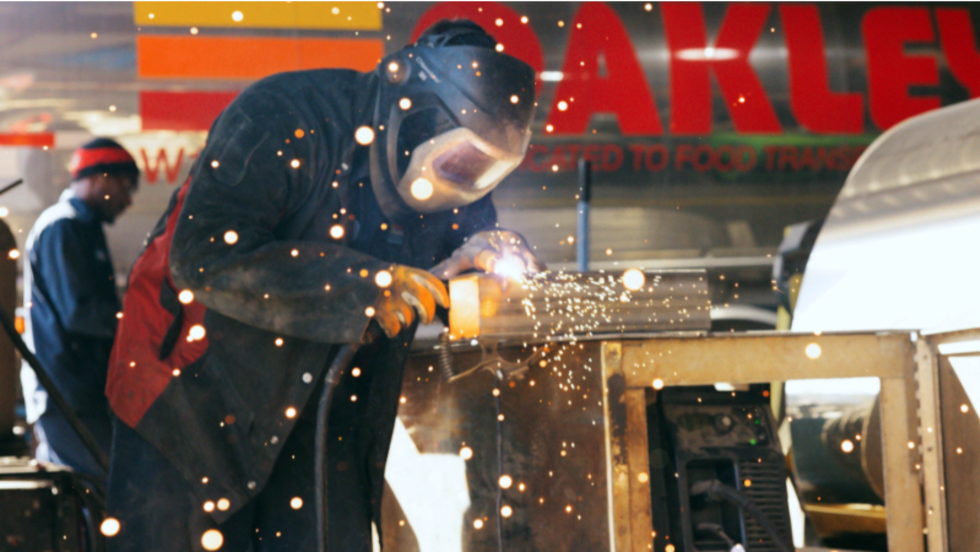 Worker is shown welding in a maintenance job in transportation industry.