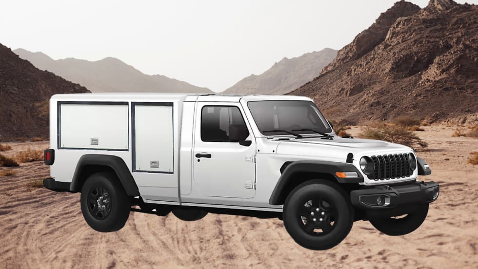 White work truck that looks like a Jeep parked in front of a desert scene.