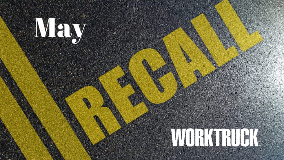 Pavement background with double yellow lines and large text that says Recall, April, and Work Truck logo.