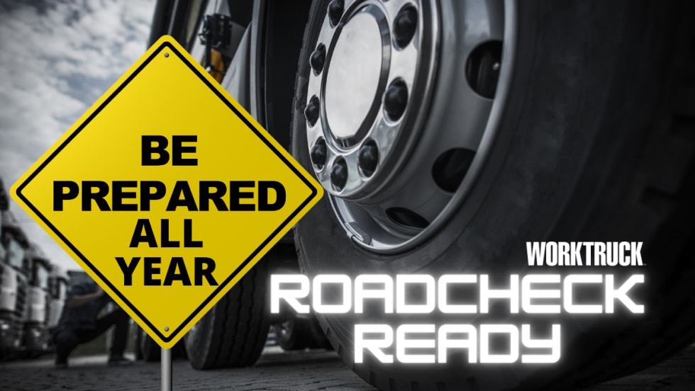 Be Preapred All Year, Work Truck Roadcheck Ready with semi-truck tires in the background 