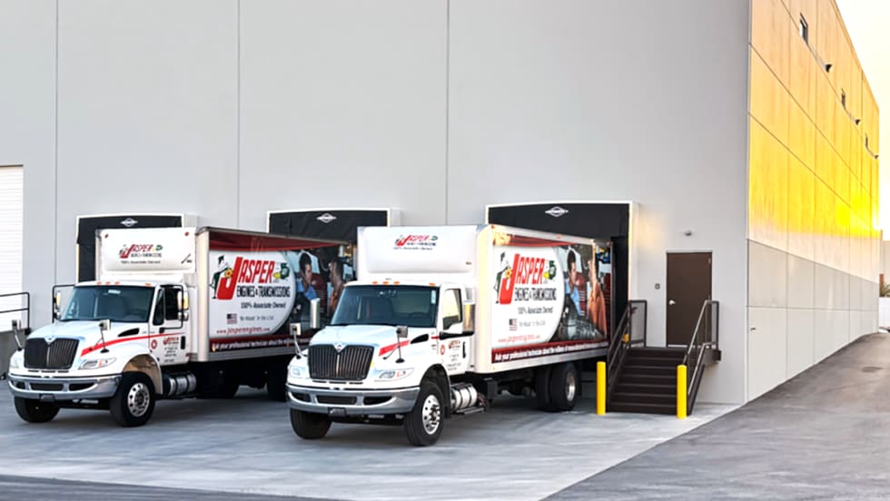 Photo of two trucks backed up to the dock at a distribution center.