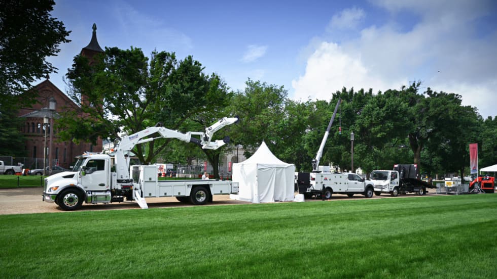 White work trucks on display.