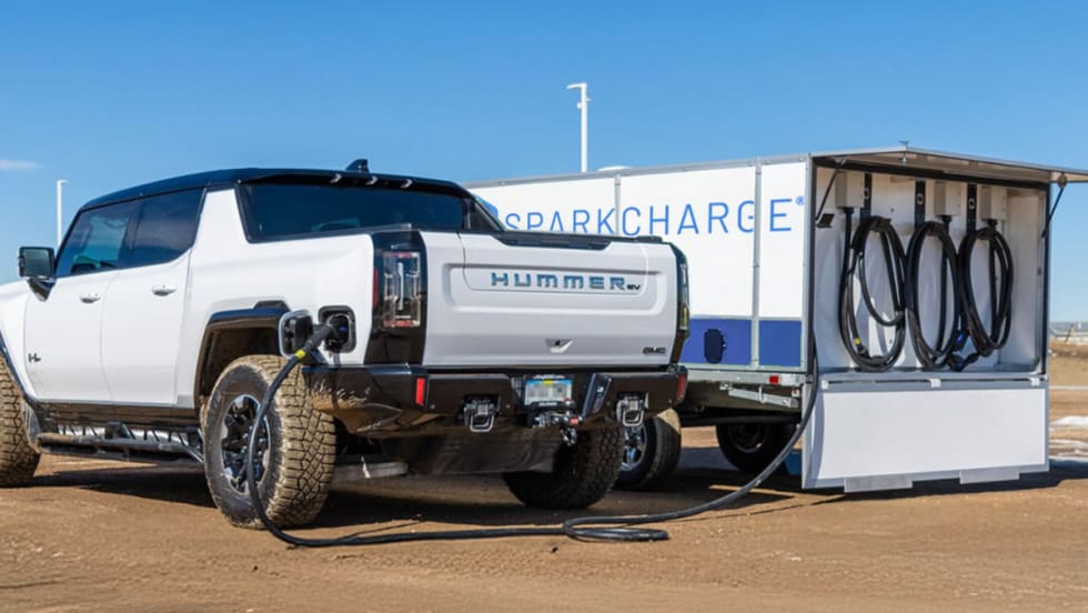 SparkCharge mobile EV charging unit powering up a Hummer EV in a remote location. 