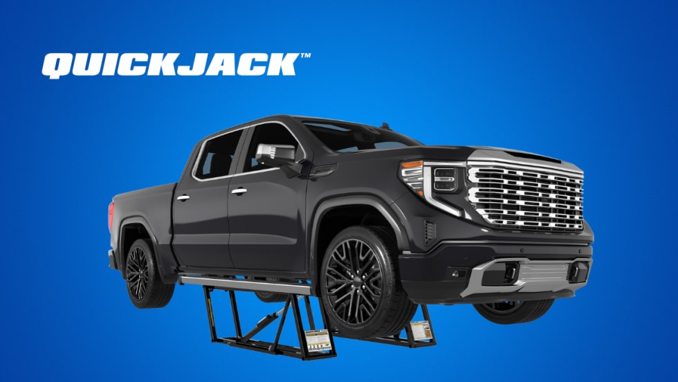 Black pickup truck on top of a car lift, against a blue background, inset white logo for QuickJack.