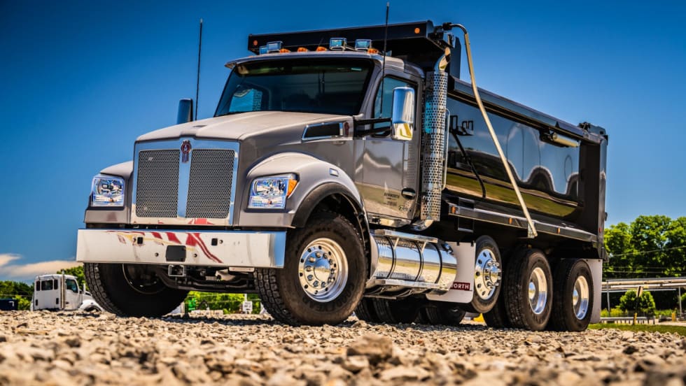 dump truck against a blue sky and parked on rocky ground