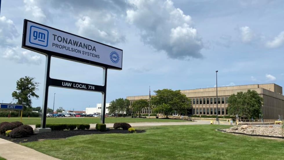 Front view of the GM Tonawanda Propulsion Systems plant in Buffalo, New York, showing the main sign with UAW Local 774 and the facility in the background on a partly cloudy day.