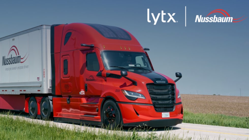 Red tractor trailer driving on a road, inset company logos for Lytx and Nussbaum.