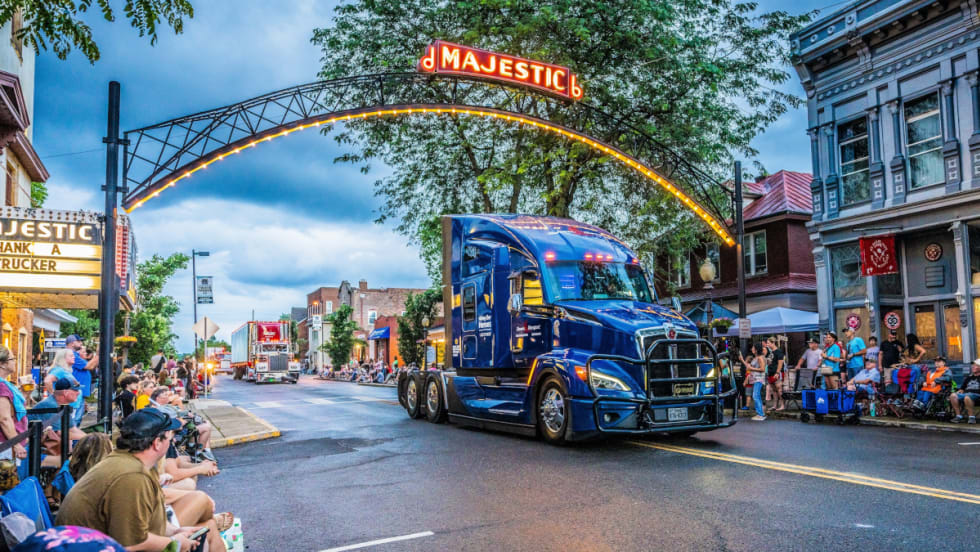 Truck in a parade at dusk.