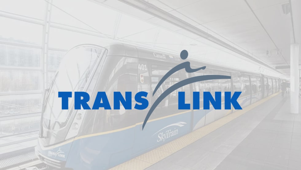 TransLink logo overlaid on a SkyTrain at a station platform in Metro Vancouver.