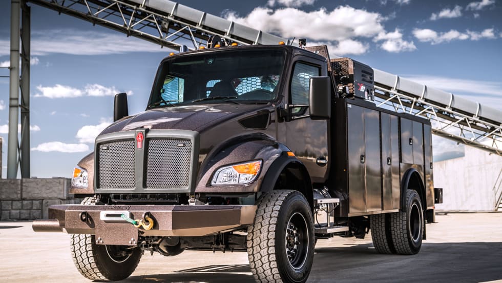 Photo of a medium-duty Kenworth service truck parked at a mine.