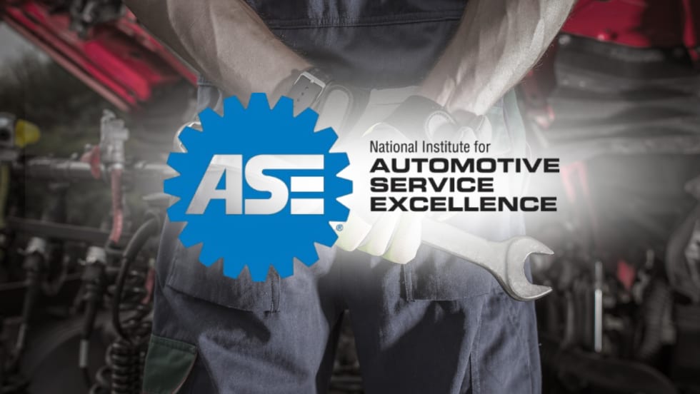 Technician holding wrench with ASE logo — ASE to discontinue five certification tests, including truck equipment and exhaust, by December 31, 2025.