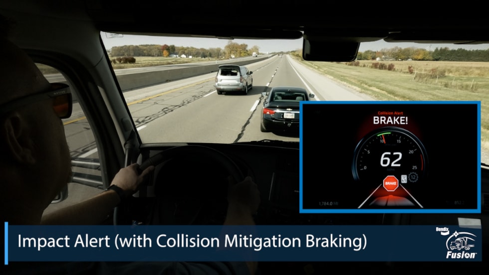 View from a truck cab showing Bendix Fusion collision alert on a dashboard display with a warning to brake at 62 mph.