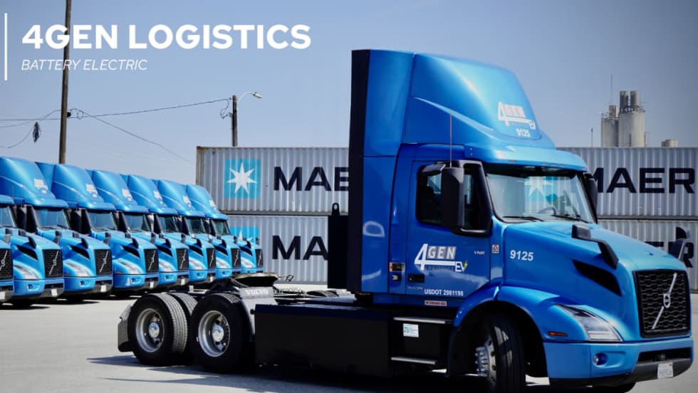 A row of blue Volvo VNR battery-electric trucks operated by 4GEN Logistics parked in front of Maersk shipping containers at a logistics yard.
