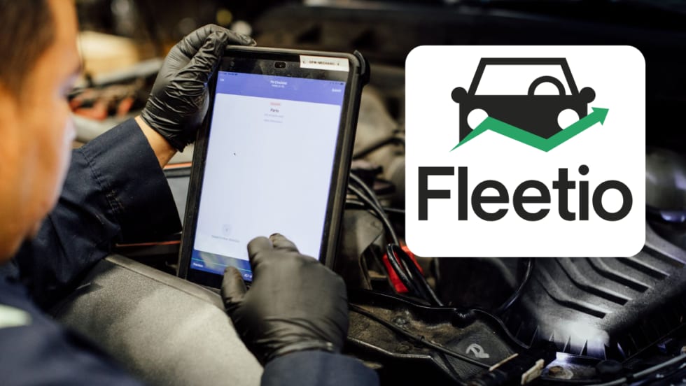 Automotive technician over an engine and using a tablet, inset logo at right for Fleetio, set against a white background box.