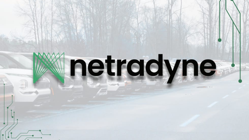 The Netradyne logo displayed over a faded background of parked fleet vehicles, with circuit-style graphics framing the corners to emphasize technology and connectivity.