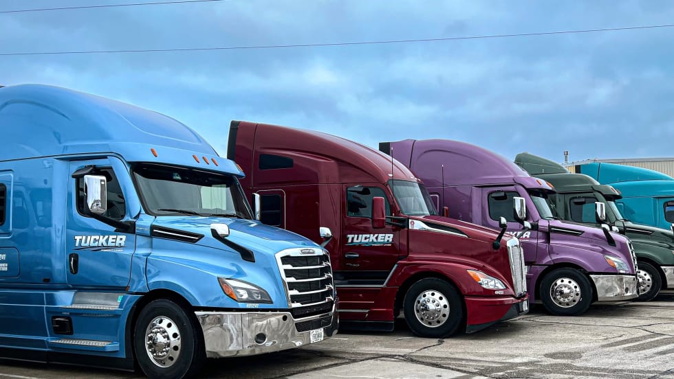 Lineup of colorful Tucker Freight Lines heavy-duty tractors