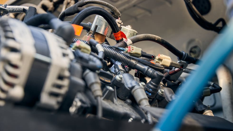 Close-up view of a propane autogas vehicle engine with wiring and components, representing technician training supported by PERC’s grant program.