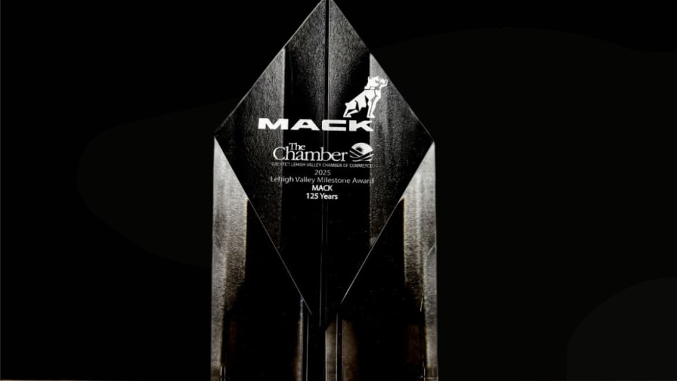 A clear crystal award engraved with “Mack” and “Lehigh Valley Milestone Award 2025 – Mack 125 Years,” displayed against a black background.