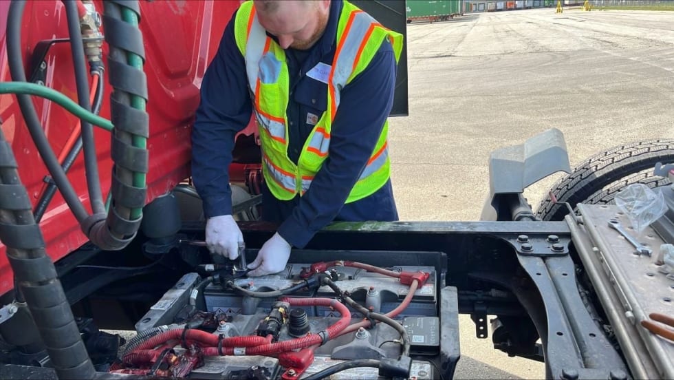 Truck technician installing Clarios' IdleLess battery monitoring system