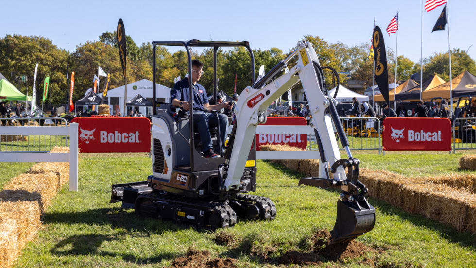 Bobcat excavator digging in the ground.