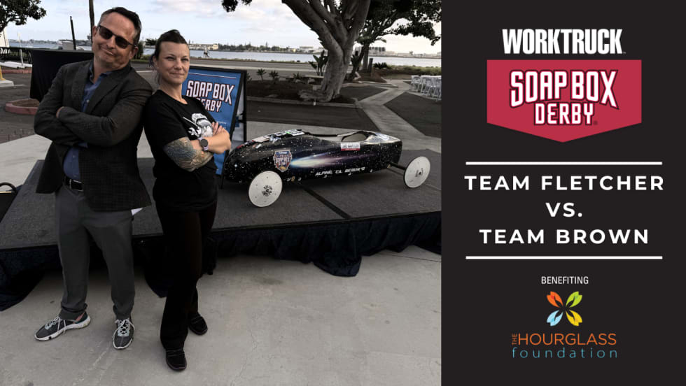 Lauren Fletcher and Chris Brown stand beside a soap box derby car ahead of the 2026 Corporate Soap Box Derby Challenge, where Team Fletcher will race to support skilled trades scholarships.