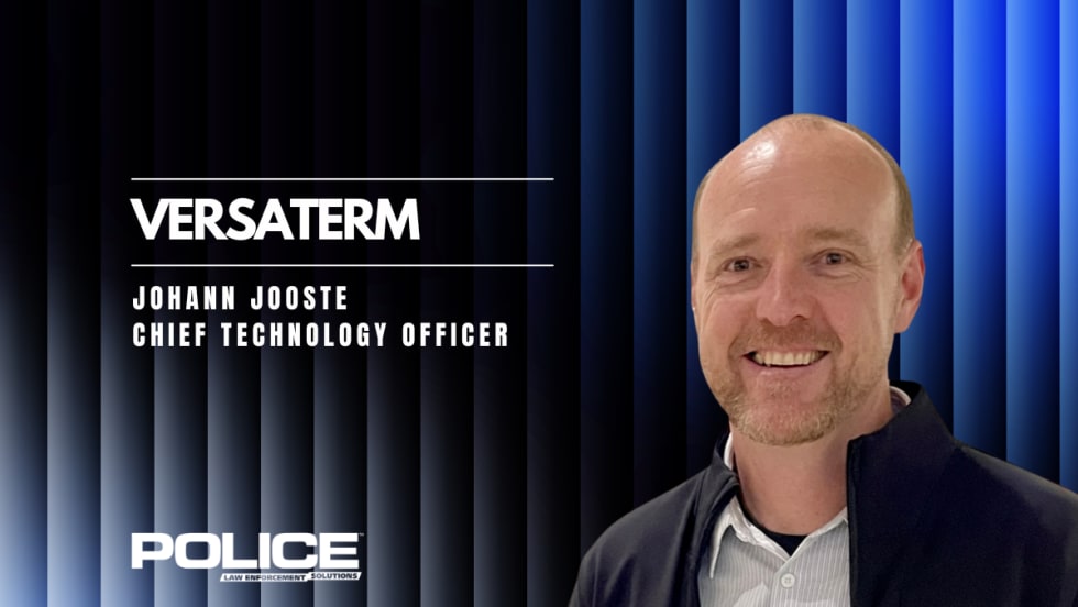 man in business attire against a black and blue corrugated background and headlines for Versaterm and the man's name and title.