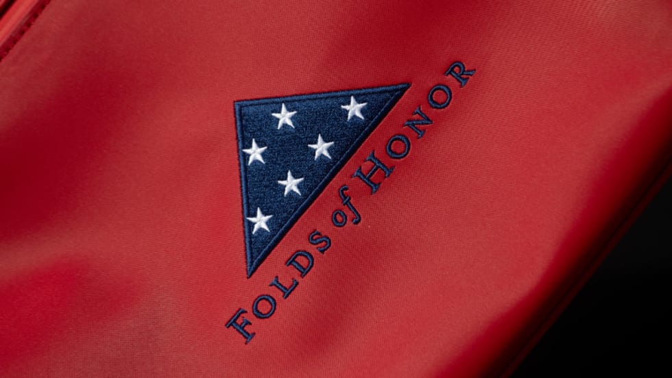Red fabric background with blue and white Folds of Honor logo.