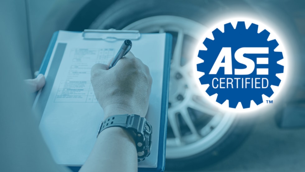 Technician writing on a clipboard in front of a vehicle wheel with ASE Certified logo displayed on the right side.