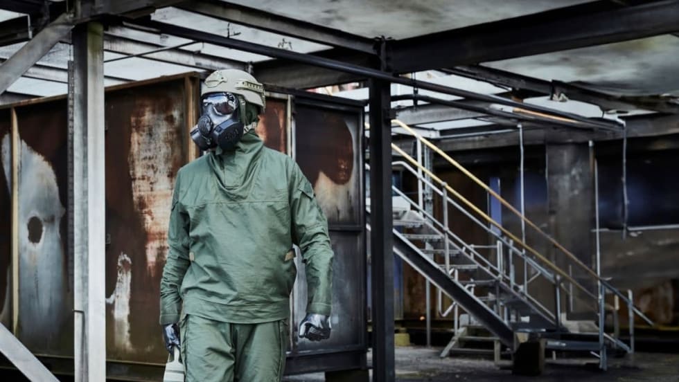 Person in protective CMRN suit and breathing gear.