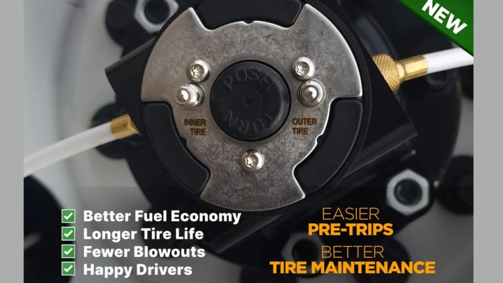 Close-up of a FlowBelow wheel cover center hub with labeled inner and outer tire valve connections and air lines attached, highlighting centralized access for tire inflation and pressure checks.